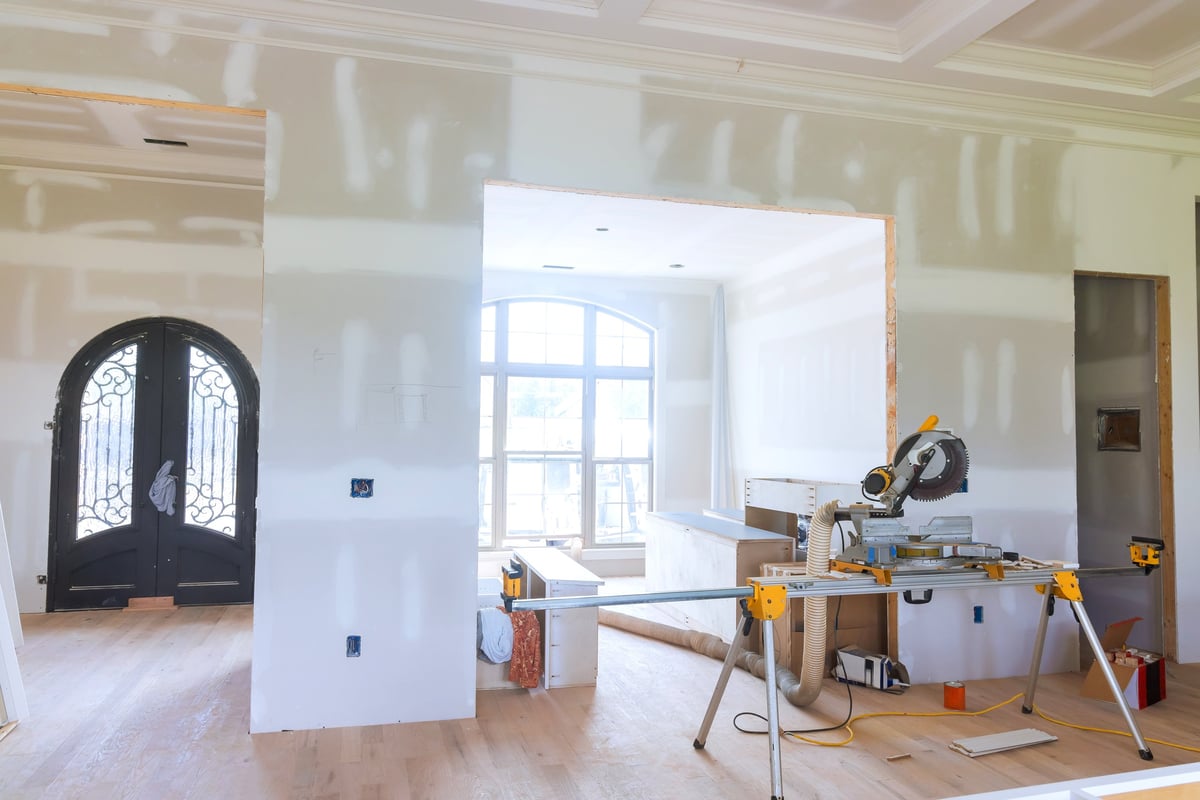 Construction worker in modern living space during renovation
